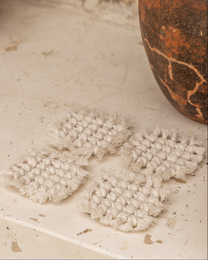 Knotted Macrame Coaster Set handmade by Village Thrive using natural materials.
