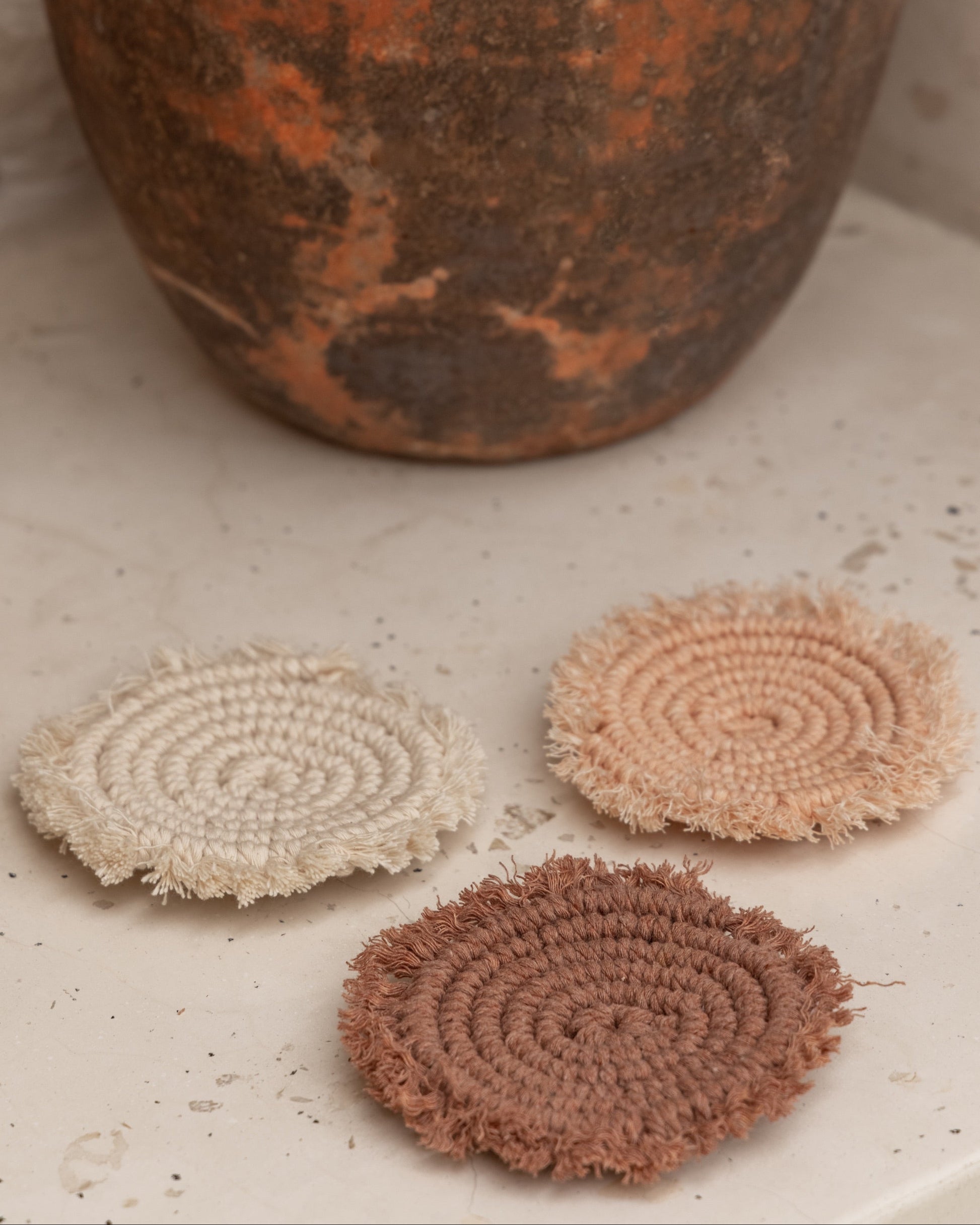 Kera Sunrise Macrame Coaster Set handmade by Village Thrive using natural materials.