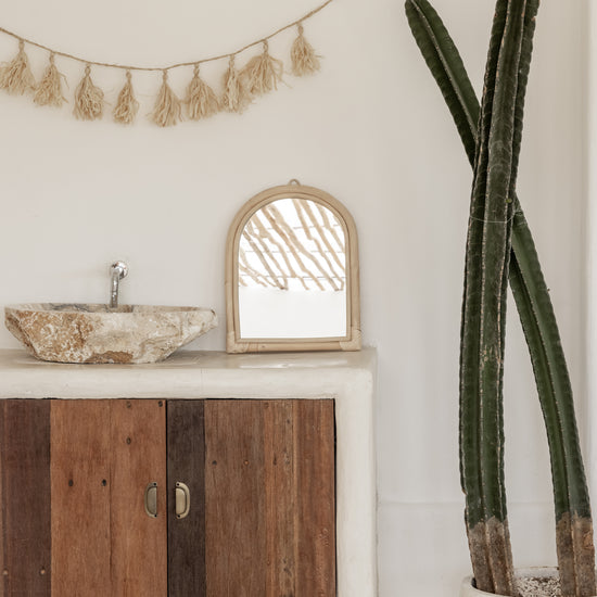 Raffia Tassel Garland handmade by Village Thrive using natural materials.