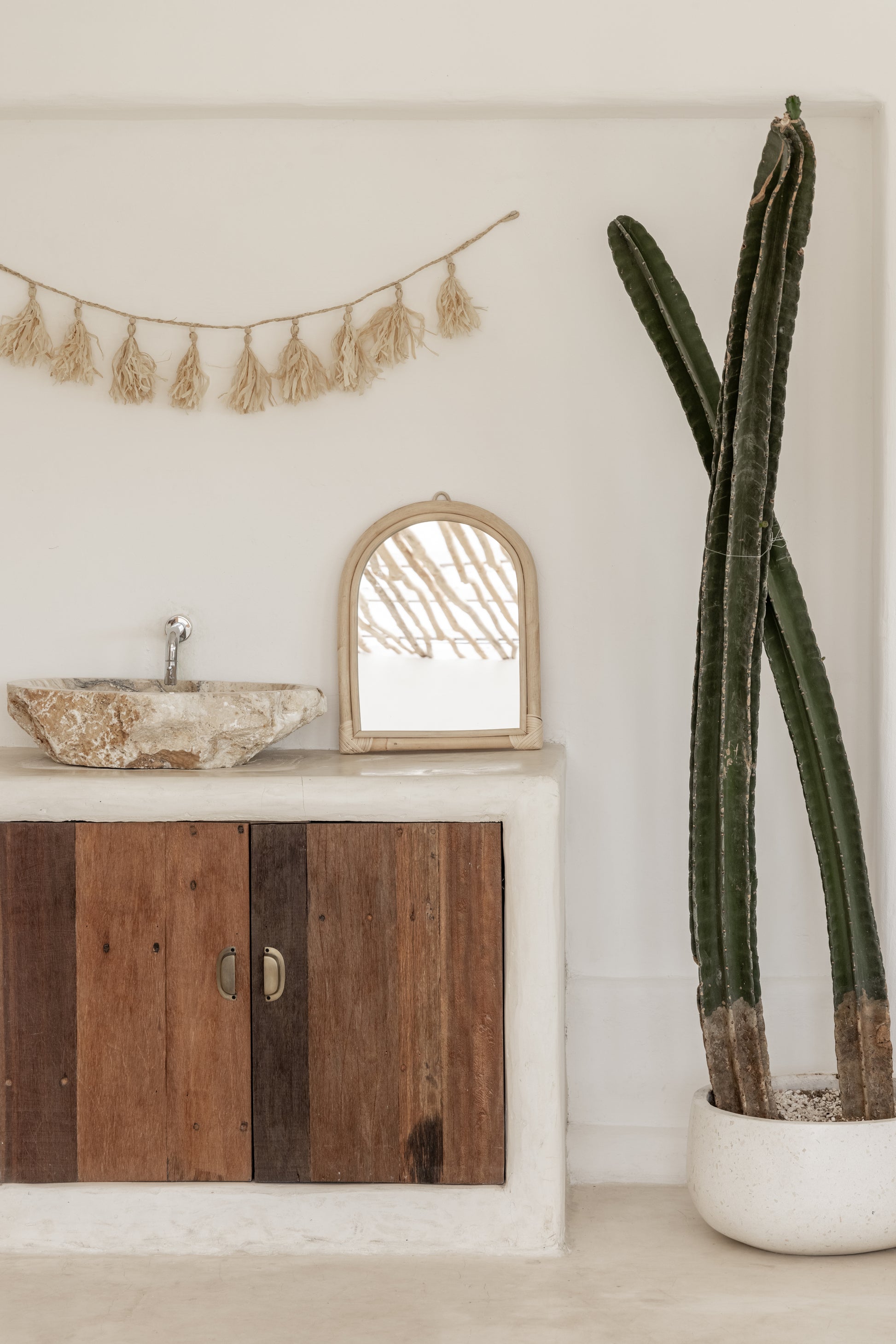 Raffia Tassel Garland handmade by Village Thrive using natural materials.