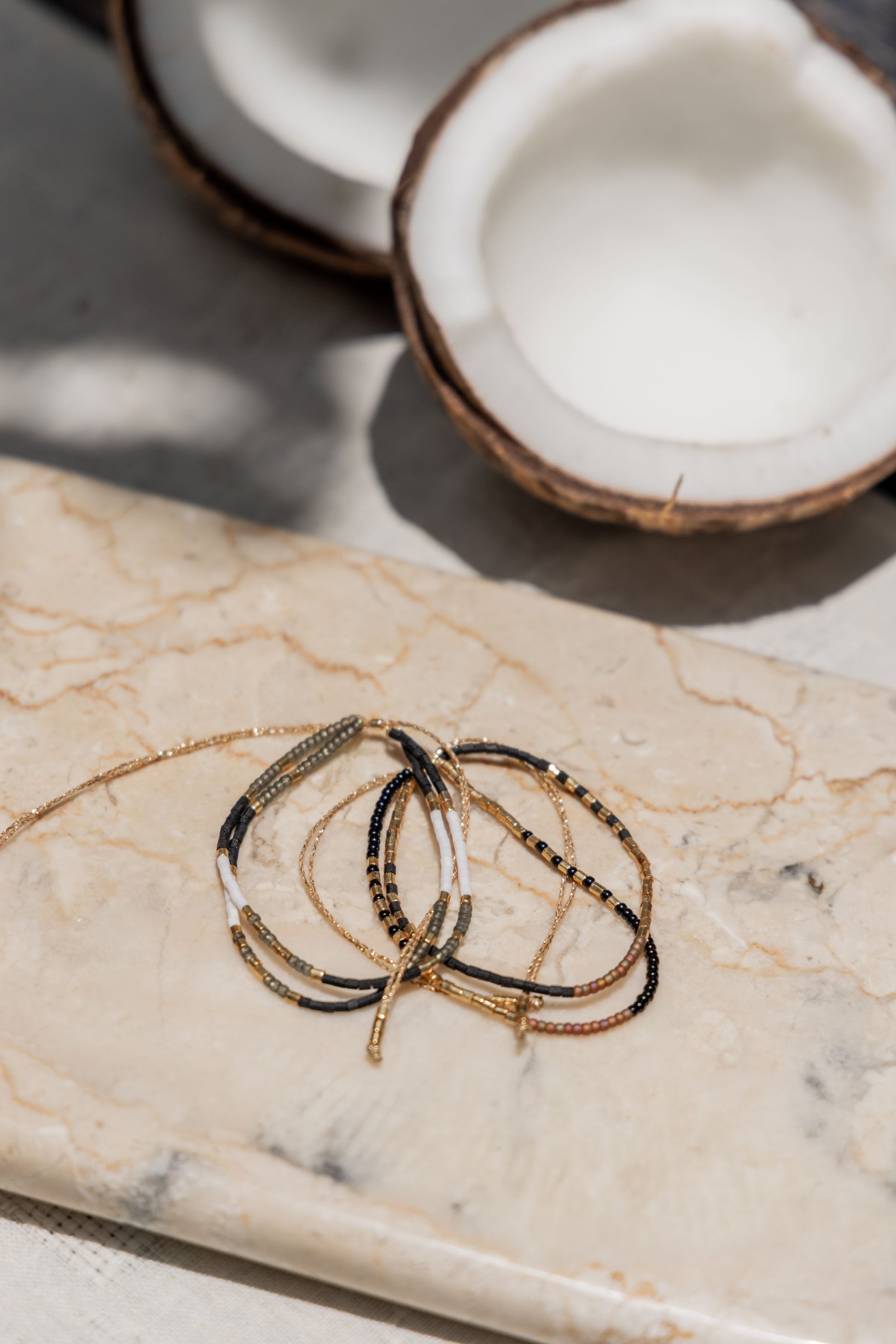 Gold Beaded Necklace and Bracelet Set handmade by Village Thrive using natural materials.