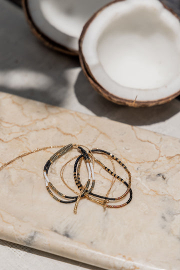 Gold Beaded Necklace and Bracelet Set handmade by Village Thrive using natural materials.