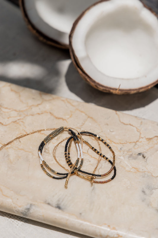Gold Beaded Necklace and Bracelet Set handmade by Village Thrive using natural materials.