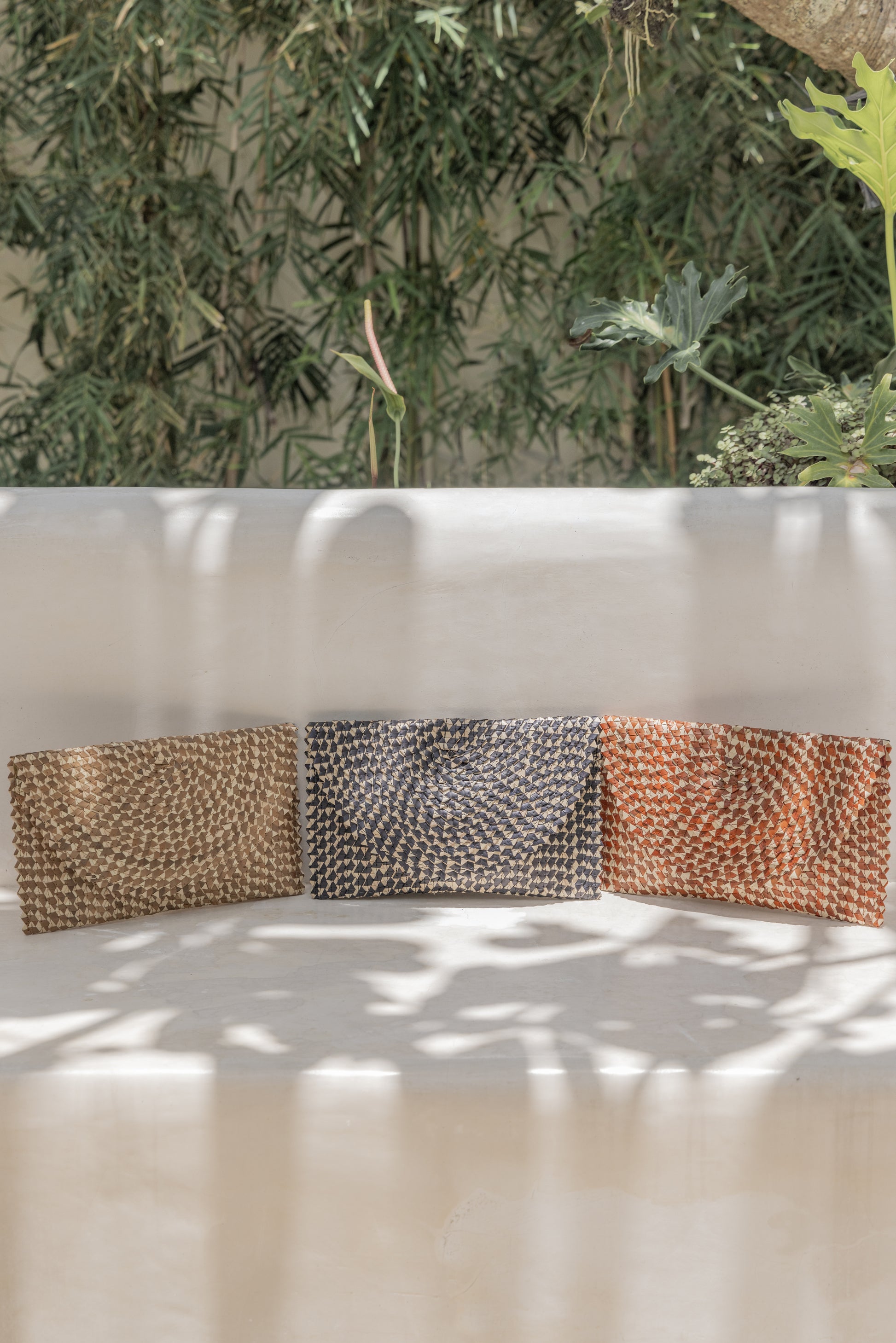 Ombre Rattan Clutch handmade by Village Thrive using natural materials.