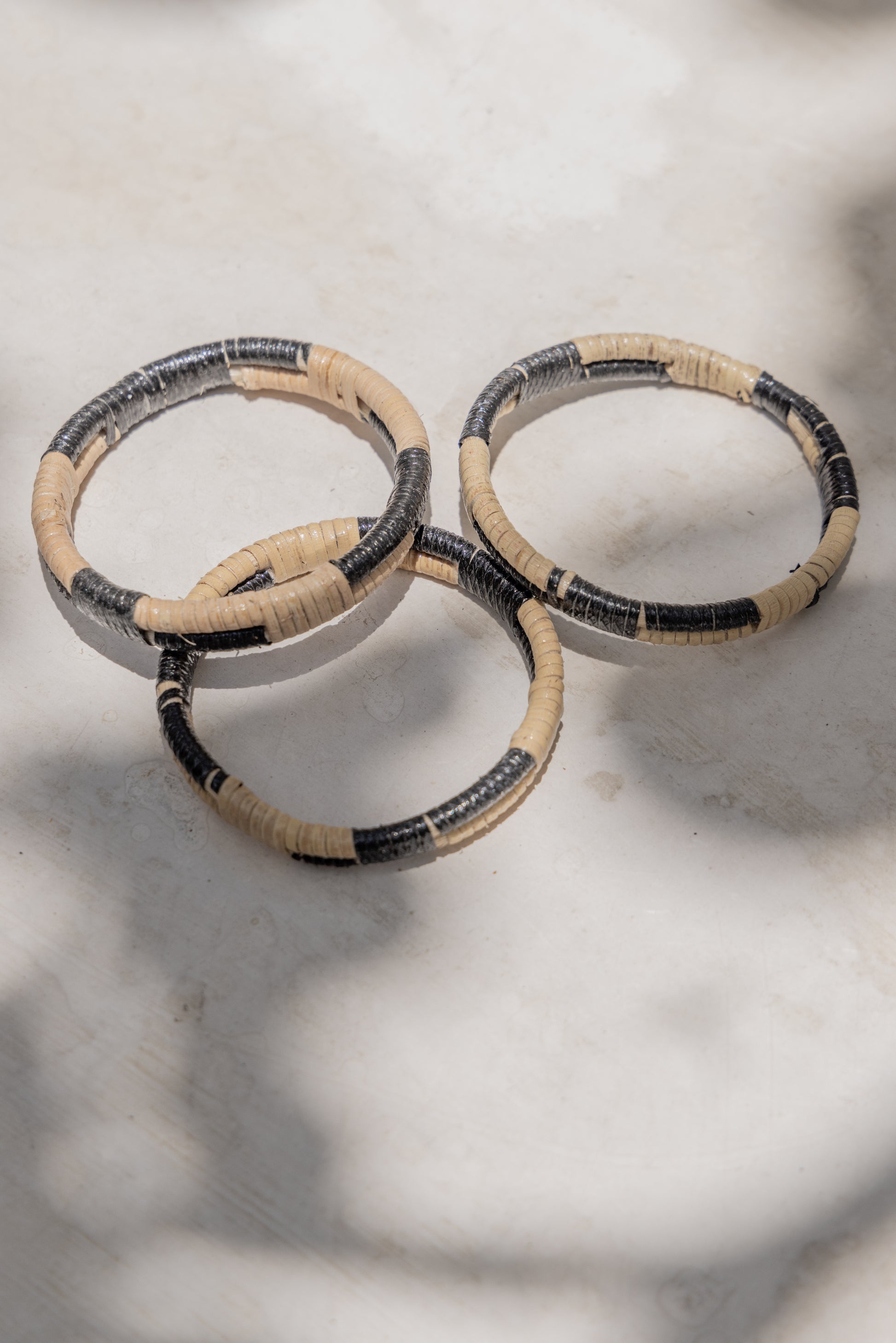 Black Motif Rattan Bangle handmade by Village Thrive using natural materials.