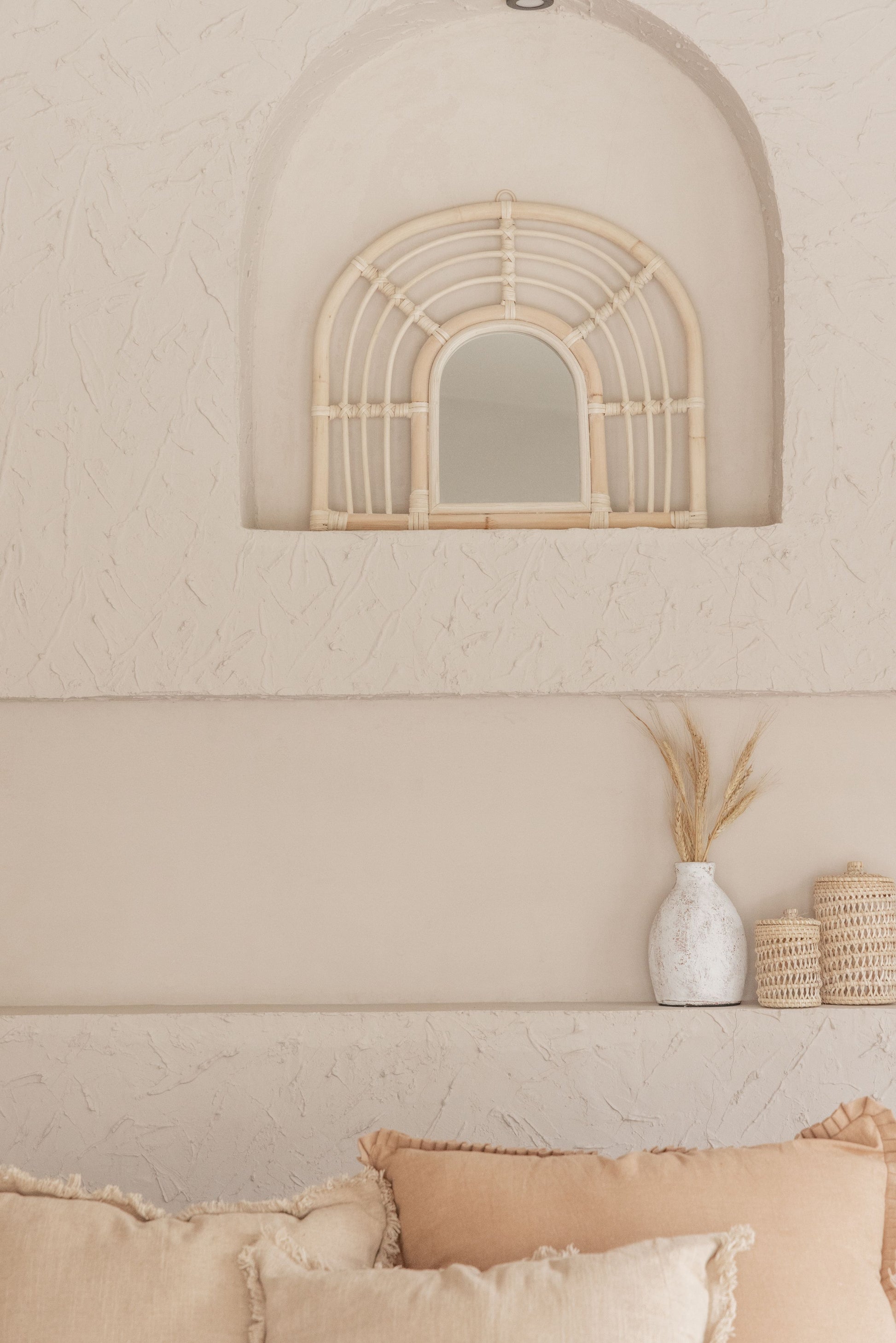 Rainbow Rattan Mirror handmade by Village Thrive using natural materials.