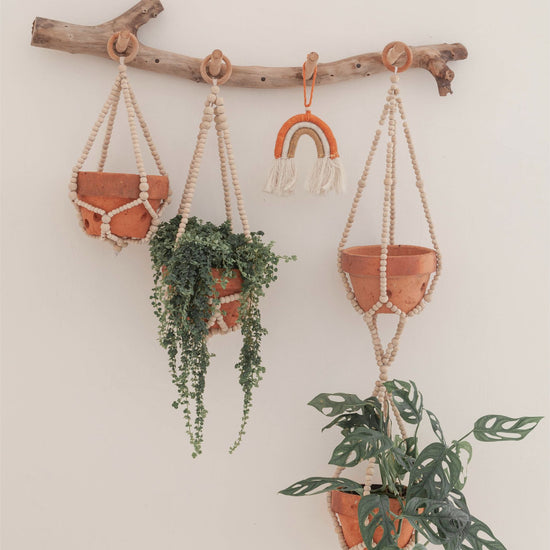 Wood Beaded Plant Hangers handmade by Village Thrive using natural materials.