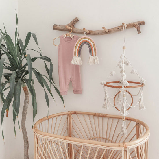Imperfect Pom Pom Baby Mobile handmade by Village Thrive using natural materials.