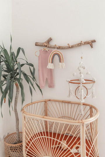 Imperfect Pom Pom Baby Mobile handmade by Village Thrive using natural materials.
