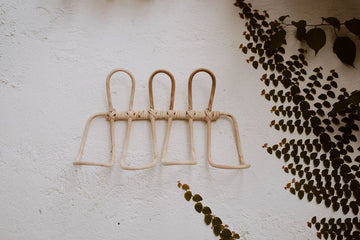 Imperfect Ombak Rattan Wall Hook handmade by Village Thrive using natural materials.