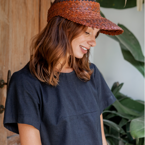 Rattan Sun Visor in Clay handmade by Village Thrive using natural materials.