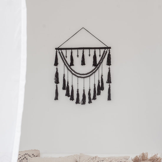 Ulu Tassel Wall Hanging handmade by Village Thrive using natural materials.