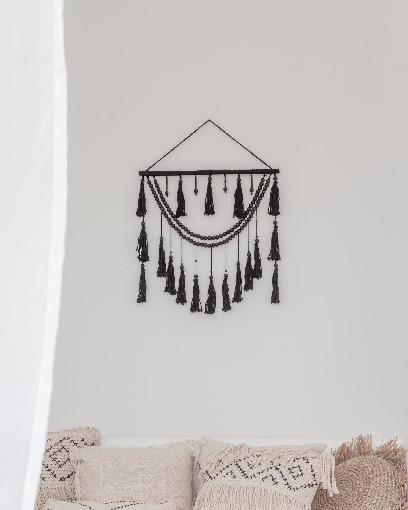 Ulu Tassel Wall Hanging handmade by Village Thrive using natural materials.