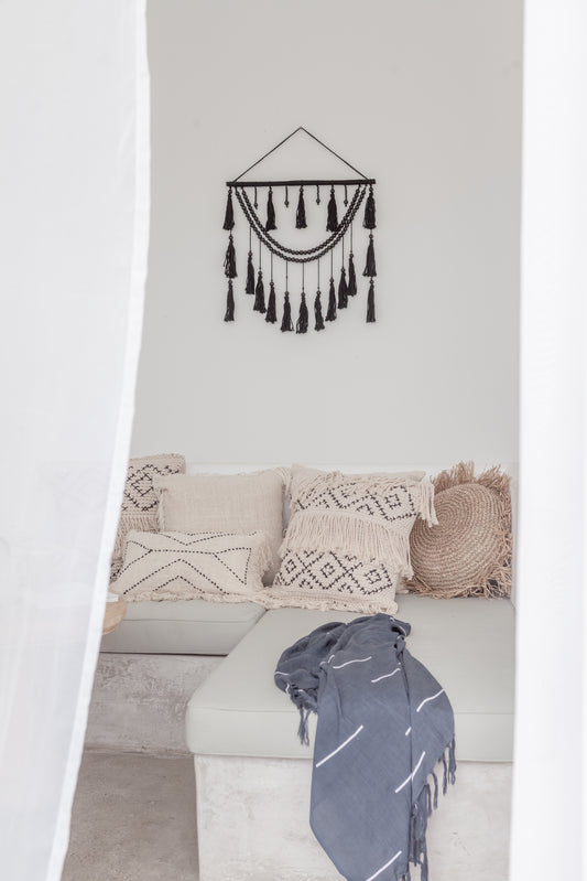 Ulu Tassel Wall Hanging handmade by Village Thrive using natural materials.