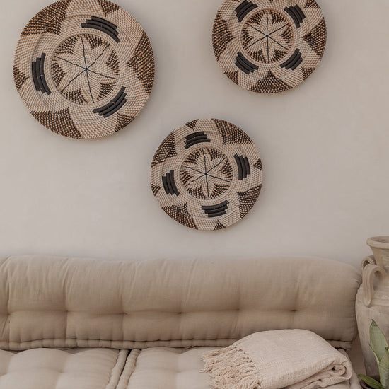 Motif Woven Wall Baskets handmade by Village Thrive using natural materials.
