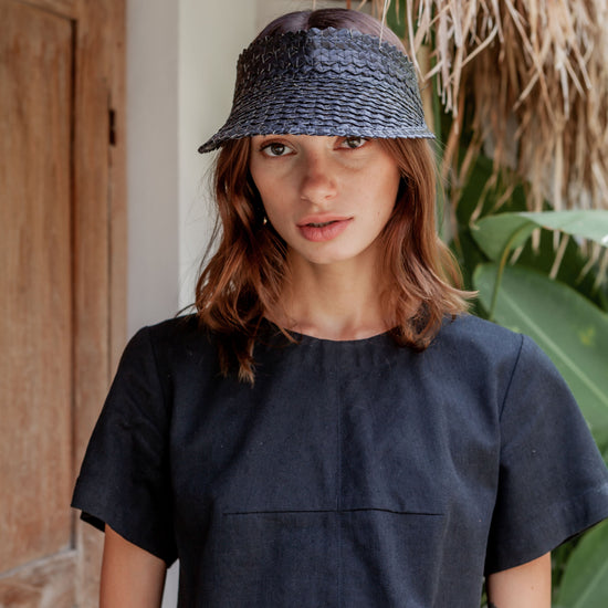 Rattan Sun Visor in Black handmade by Village Thrive using natural materials.