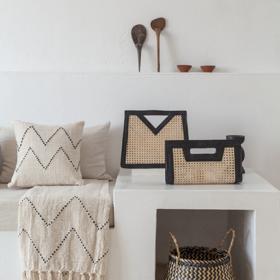 Imperfect Raja Leather and Cane Clutch handmade by Village Thrive using natural materials.