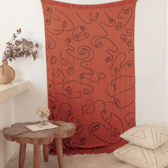 Imperfect Faces Tapestry handmade by Village Thrive using natural materials.