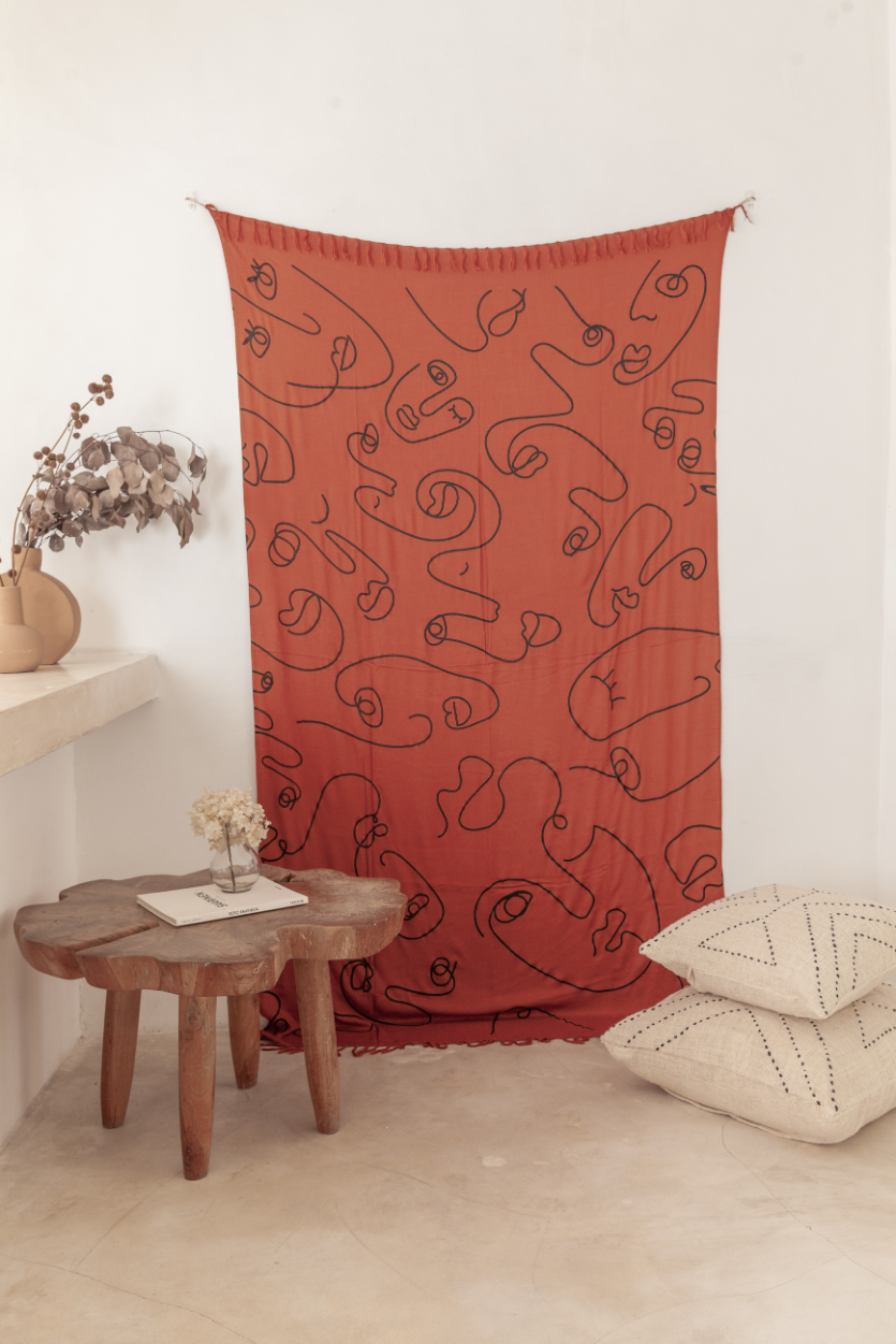 Imperfect Faces Tapestry handmade by Village Thrive using natural materials.