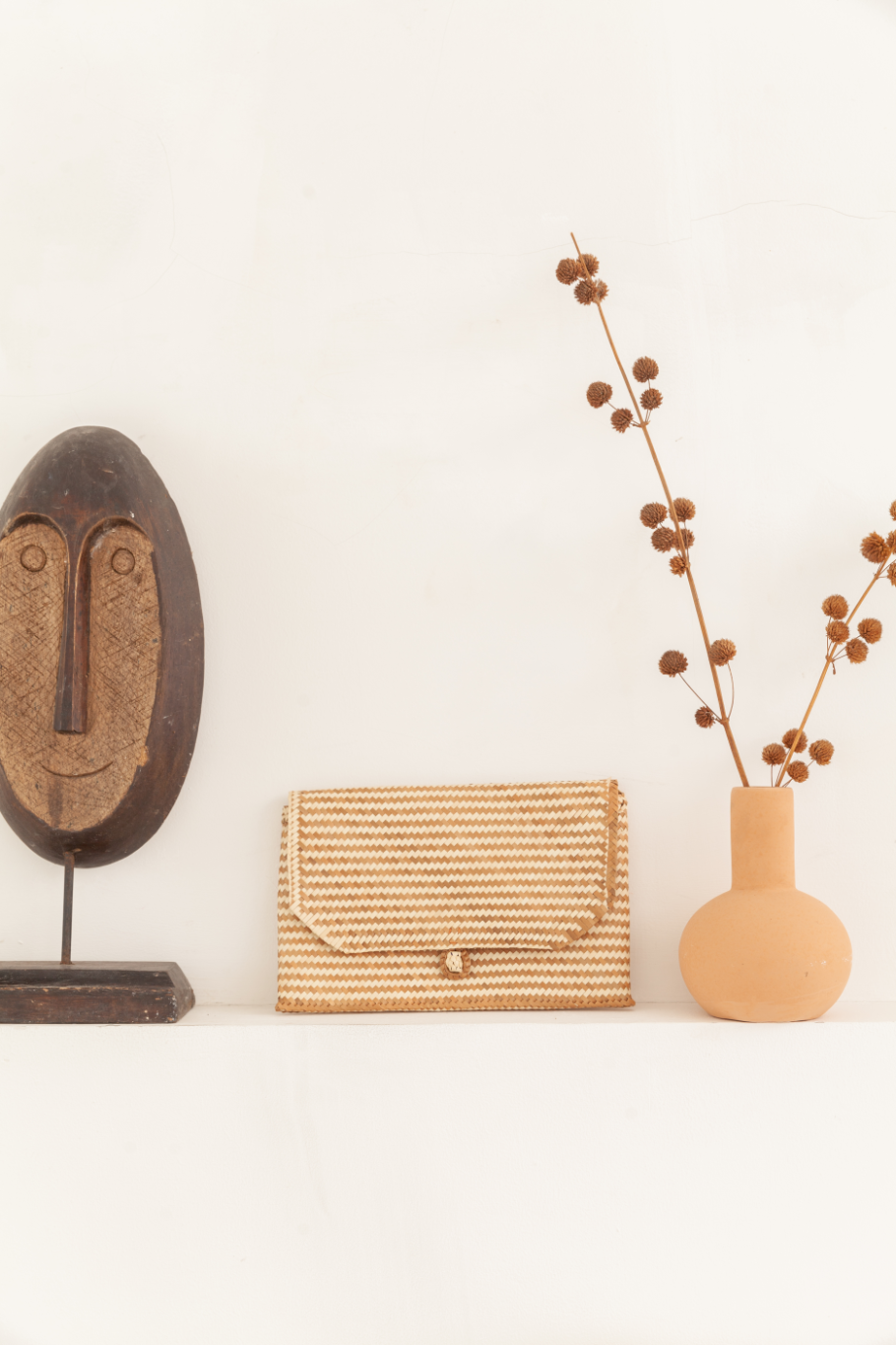 Imperfect Rattan Patterned Clutch handmade by Village Thrive using natural materials.
