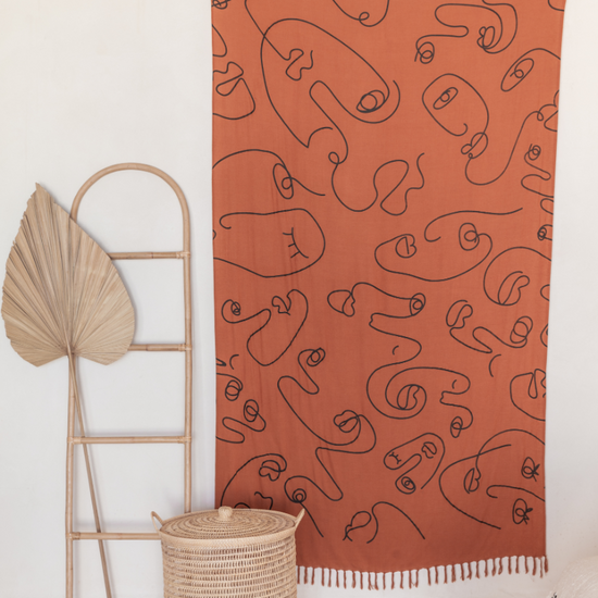 Faces Tapestry handmade by Village Thrive using natural materials.