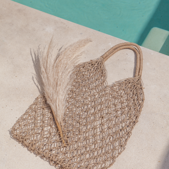 Natural Net Market Tote handmade by Village Thrive using natural materials.