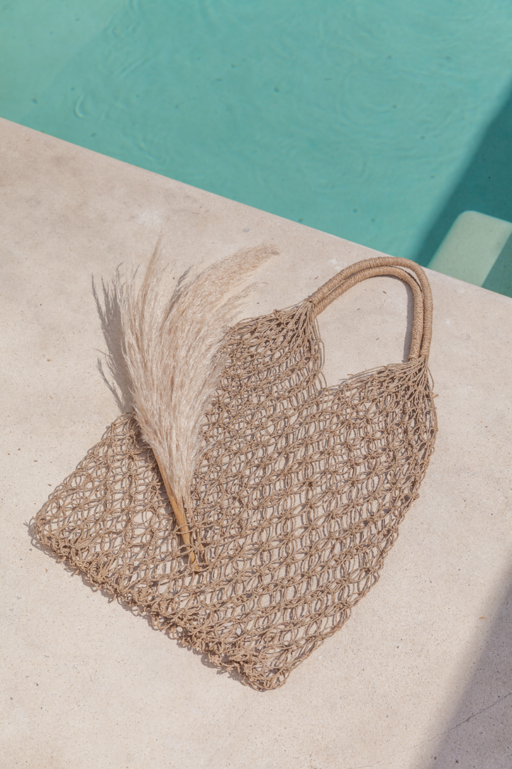 Natural Net Market Tote handmade by Village Thrive using natural materials.