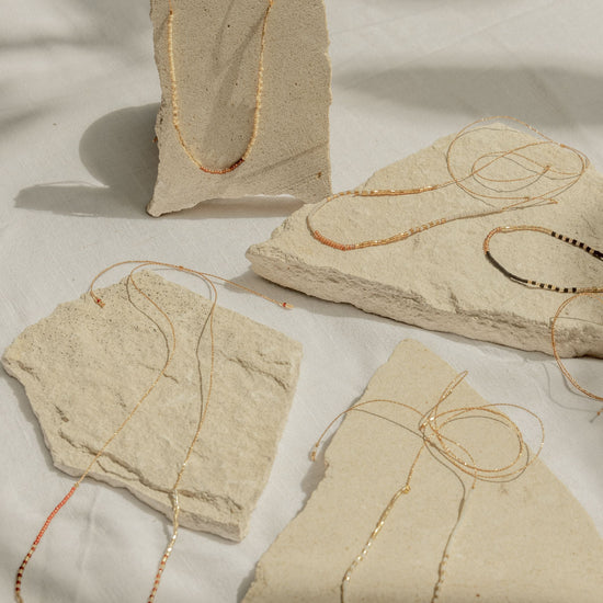 Golden Beaded Necklace handmade by Village Thrive using natural materials.