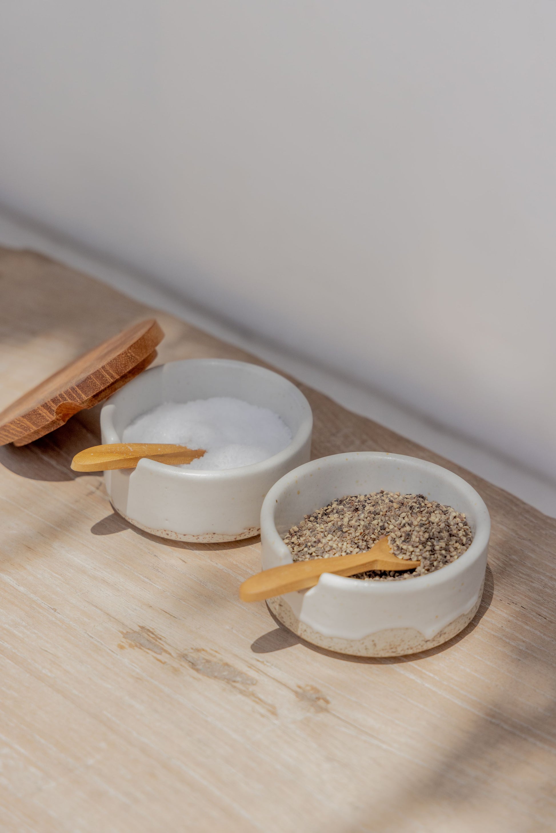 Wabi Ceramic Salt & Pepper Holder handmade by Village Thrive using natural materials.