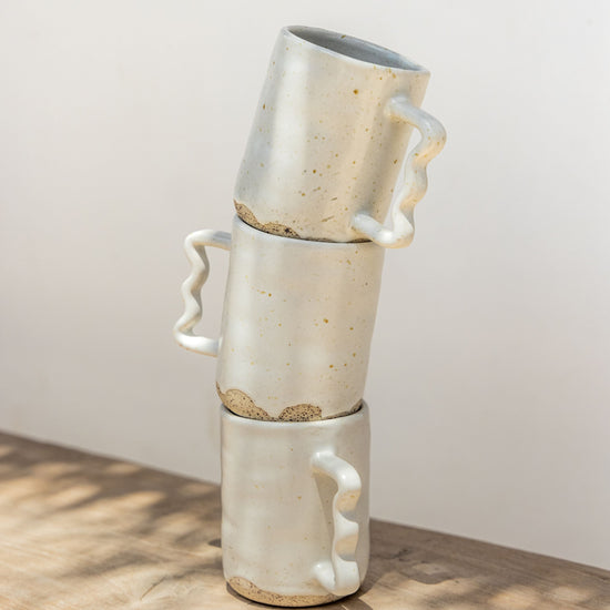 Wabi Ceramic Wavy Mug handmade by Village Thrive using natural materials.