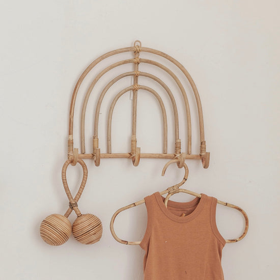Rainbow Rattan Wall Hook handmade by Village Thrive using natural materials.