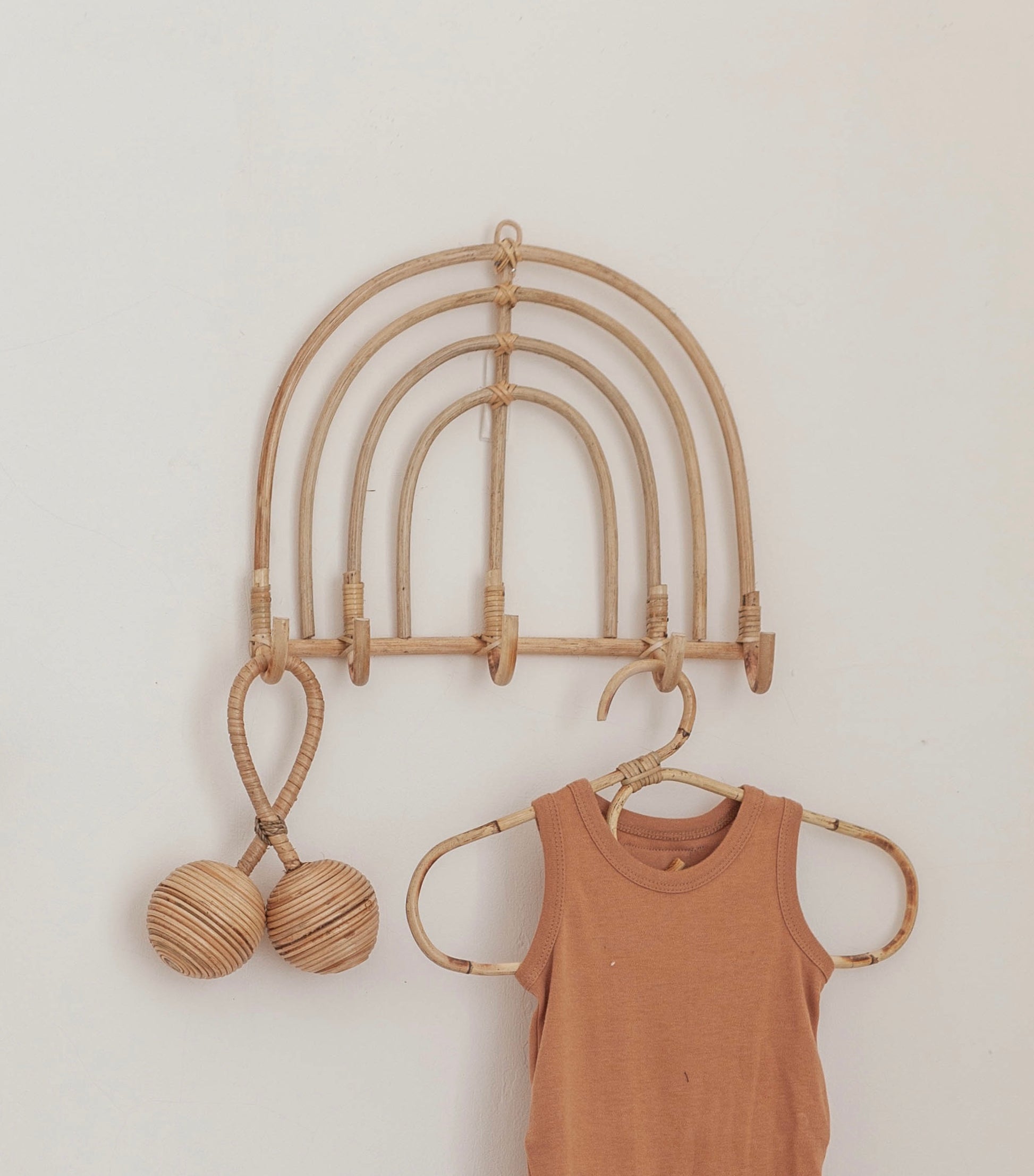 Rainbow Rattan Wall Hook handmade by Village Thrive using natural materials.