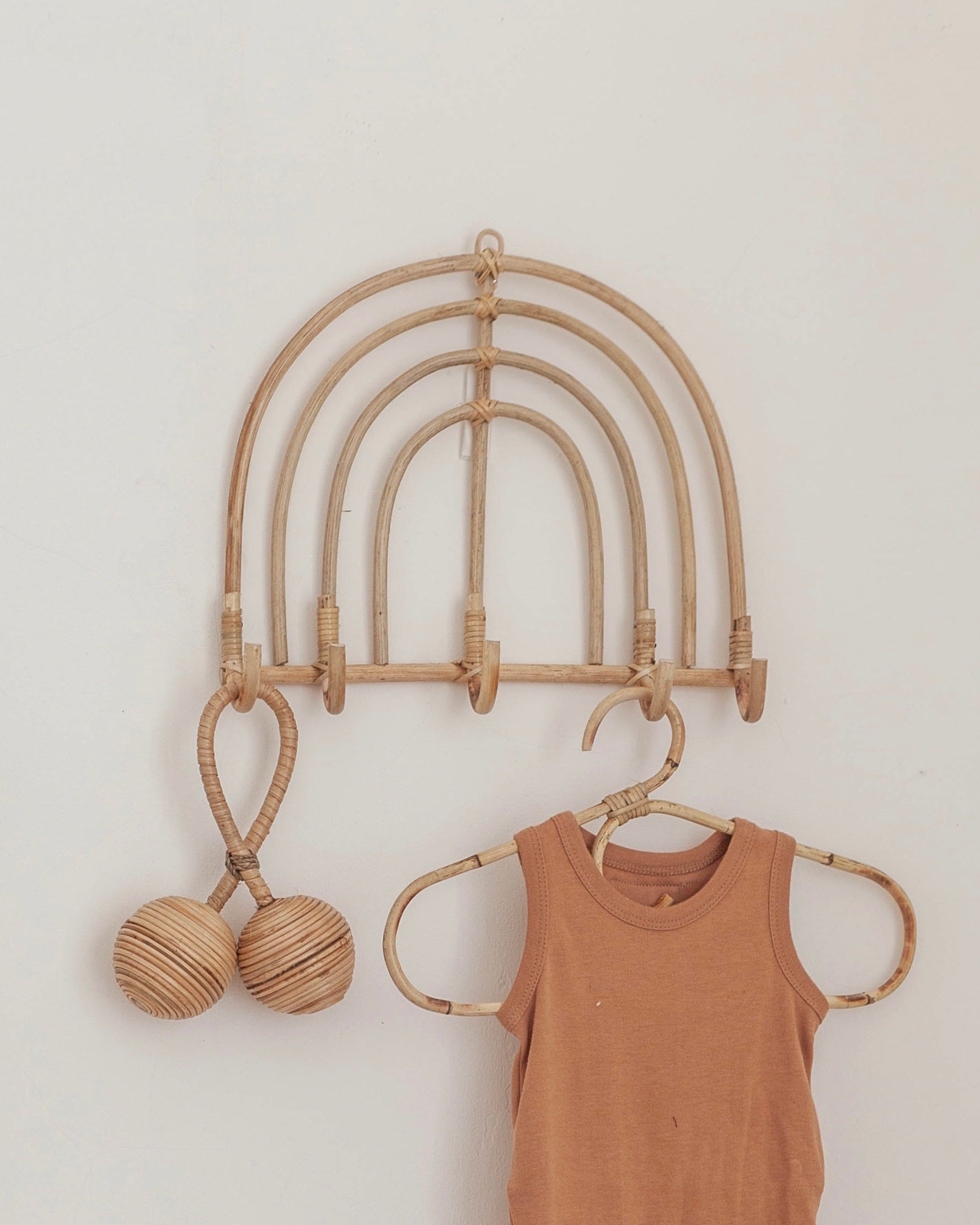 Imperfect Rainbow Rattan Wall Hook handmade by Village Thrive using natural materials.